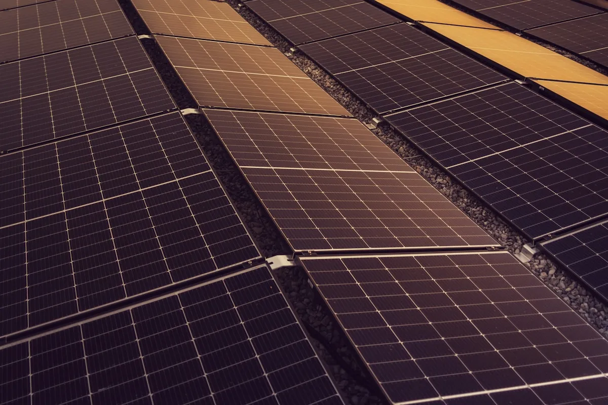 Rows of solar panels mounted across a warehouse roof